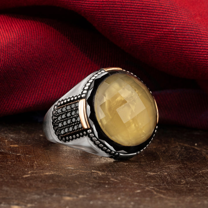 Circle yellow Zultanite stone ring has small like stone details on side with red silk background on brown ground