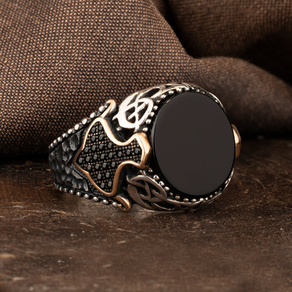 Black Onyx Stone with Small Black Zircon Stones on the Side Circle Silver Ring on brown ground and brown silk background  